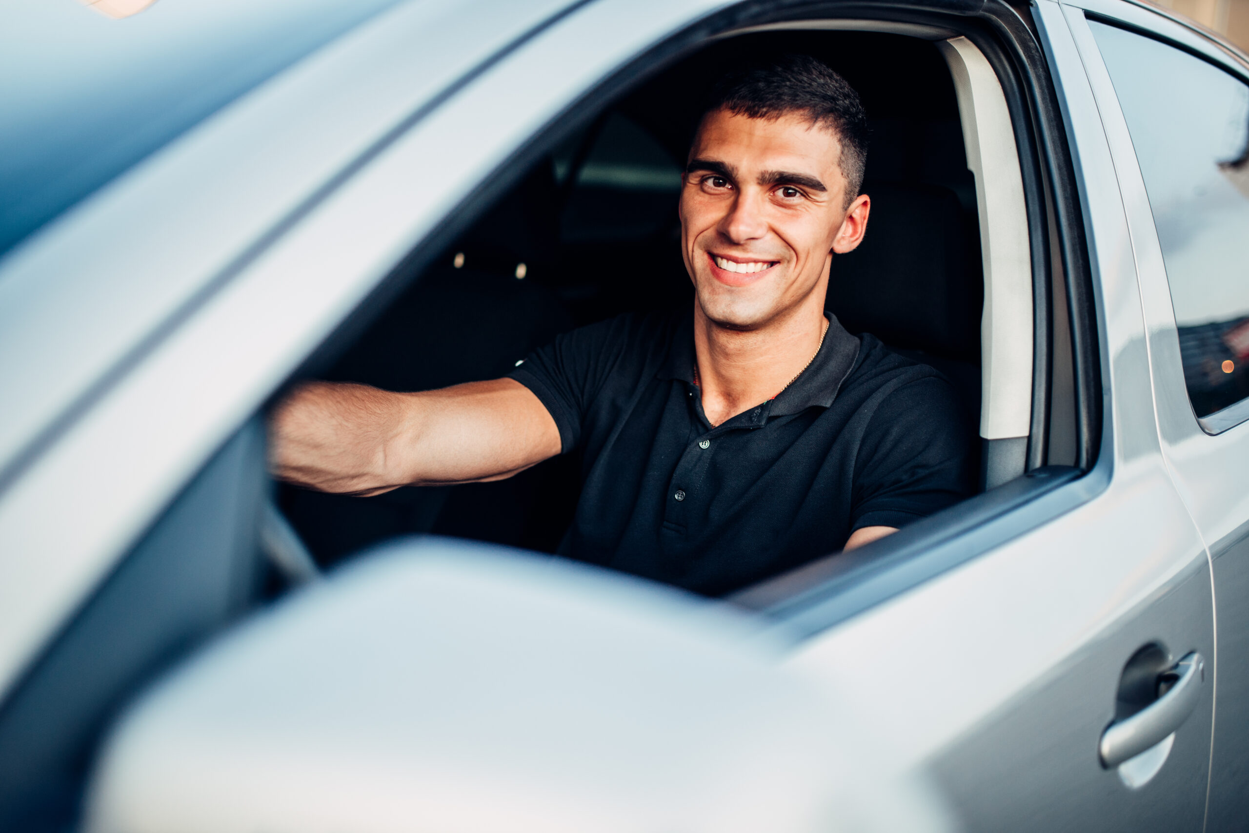 Happy male driver in car, advertising concept. Automobile driving